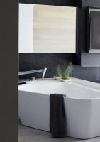 Modern corner bath in monochrome bathroom