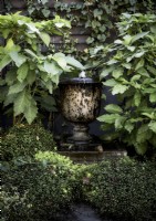 Urn water feature in garden - detail