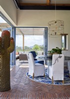 Quirky modern cactus sculpture in country dining room with a view