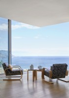 Animal print armchairs facing sea view in contemporary living room