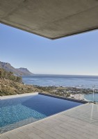 Swimming pool and contemporary terrace with coastal views
