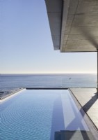 View of swimming pool and sea view from contemporary terrace