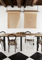Rolls of art paper hanging on wall of modern rustic dining room