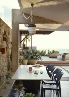 Contemporary dining area with view to outdoor living area on terrace