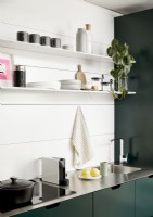 Modern green and white kitchen with stainless steel worktop