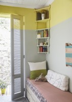Yellow and grey split painted walls in country bedroom