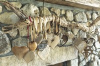 A collection of unique hearts collected from faraway trips takes center stage on the the stone fireplace.