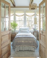 Ample windows and high ceilings give the guest bedroom an airy, relaxed and inviting mood.