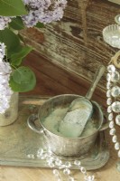 Detail of bath salts in silver bowl  on silver tray and detail of crystals from candelabra.