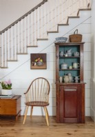 â€œWe treated the antique pieces like sculpture, silhouetting them against the bright shiplap and paneling so they would stand out,â€ explains designer  Janet Lohman. 