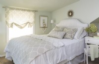 In the long and narrow master bedroom, Rachel makes space for the bed by skipping traditional nightstands and instead uses a diminutive shelf and wall lamp on one side and a small dressing table on the other.