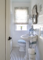 Most everything in the bathroom is original to the house simply freshened up with white paint and clip-on shades for the wall sconces; textiles usher in color.
