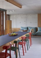 Concrete walls and large floor cushions in modern dining room
