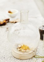 Detail of decorative glass jar with ground ginger root inside