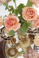 Roses on a glass tray with brass ornaments