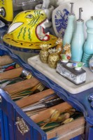 Detail of kitchen ornaments and open cutlery drawer