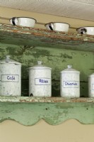 The old shelf displays some of Michelle's inherited collection of antique canisters. 