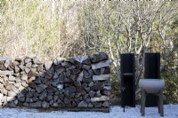 Wooden logs stacked outdoors.