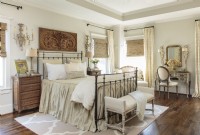 The master bedroom centers on a grey and cream color scheme with a reproduction Parisian architectural find.