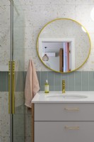Pastel bathroom with round large mirror