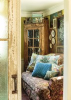 A medley of pillows, some vintage, some new from Jenniferâ€™s original designs, bring the turquoise theme into the den. 