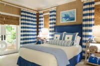 Blue and white fabrics give the boy's room a nautical mood.
