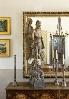 A rare 18th century statue of the angel Gabriel takes place of pride on the sideboard.
