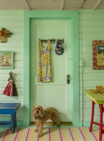 The colorful door opens to the kitchen from the back porch.