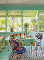 The enclosed back porch opens to the tropical garden.