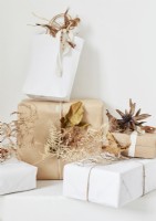 Detail of Christmas gifts decorated with dried plants