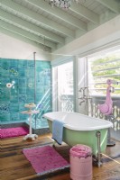 A barely there glass shower and a window let in the view to the beach.