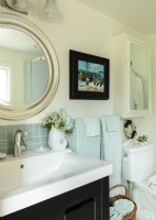 Glass backsplash tiles, a new vanity, a round mirrorâ€“â€“that recalls a porthole, make thermal bathroom pretty and comfortable.