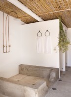 Shower in rustic bathroom with reed ceiling