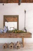 Mirror, ceramics, fruit and candle holder on old workshop table
