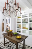 Glassware displayed on wall shelves in country kitchen
