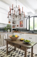 Chandelier over simple wooden table in country kitchen