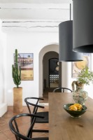 Large black lampshades over wooden dining table