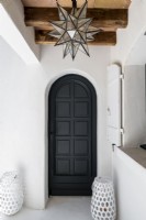 Black painted wooden door with white wall surround