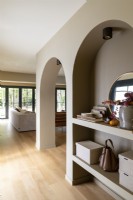 Niche shelves in arched wall - room dividers in open plan living space