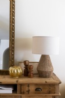 Lamp with sisal base and golden pumpkin on sideboard