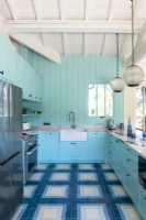 Butler sink in blue kitchen