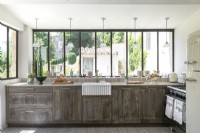Distressed wooden country kitchen with garden views in summer
