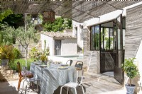Covered outdoor dining area on terrace of country house 