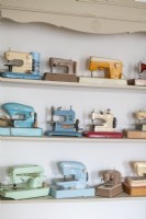 Display of miniature sewing machine models on shelves