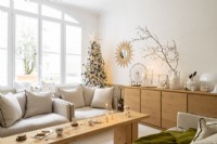 Neutrally decorated living room with Christmas tree 