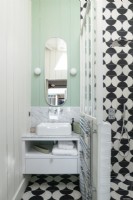Blue painted wooden walls and monochrome tiling in modern bathroom