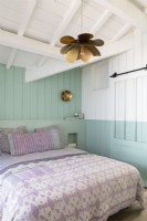 Blue and white painted wooden country bedroom with pink bedding