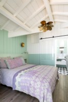 Pale blue and white painted wooden country bedroom