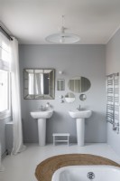 Twin sinks in modern grey and white bathroom