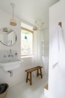 Simple white bathroom with wooden accessories 